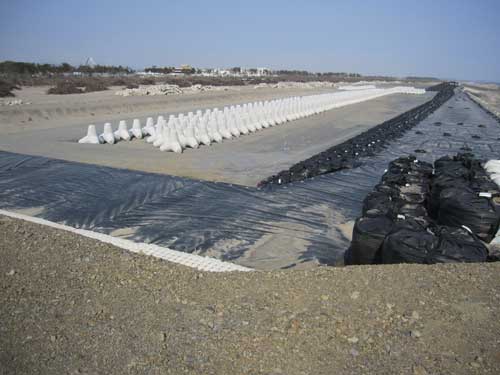 Figure 12. Repaired defences and the tetrapods that will form part of the new defences. 